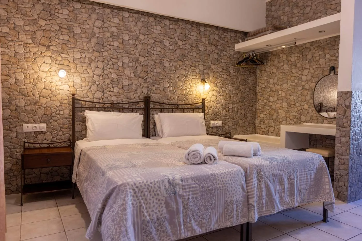 Twin studio with stone-pattern wall