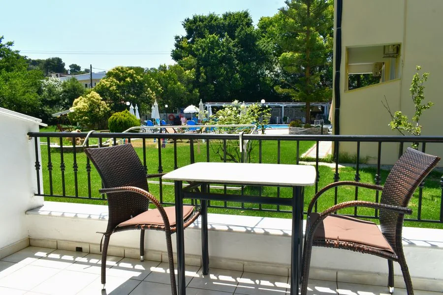 Furnished private balcony overlooking the pool and garden