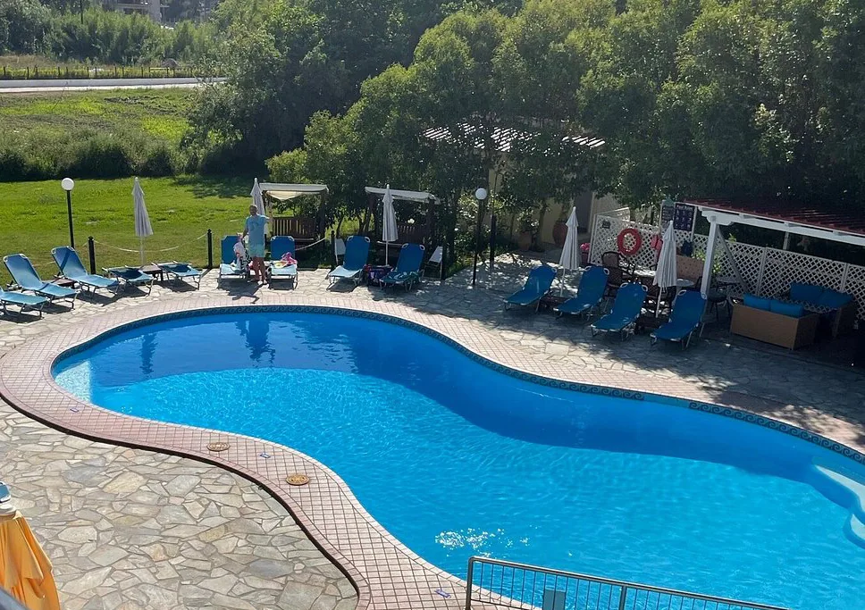 Pool with sun loungers and umbrellas