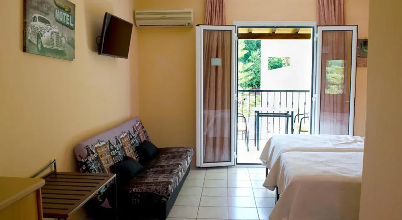 Studio bedroom opening onto a balcony